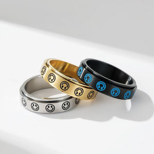 Three rings with smiley face and circle designs on a white background