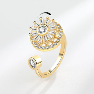 Gold ring with diamond accents on a light gray background