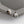 A pair of silver-colored stud earrings featuring a spaceman and star design, displayed on a mannequin bust.