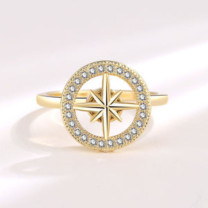 A gold-plated, hypoallergenic Star Anxiety Fidget Spinner Ring with a cubic zirconia centerpiece on a white background.