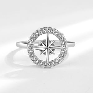 A gold-plated, hypoallergenic Star Anxiety Fidget Spinner Ring with a cubic zirconia centerpiece on a white background.