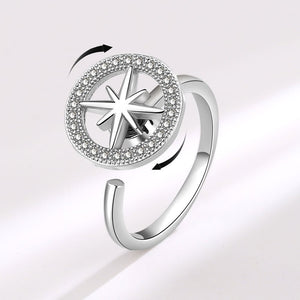 A gold-plated, hypoallergenic Star Anxiety Fidget Spinner Ring with a cubic zirconia centerpiece on a white background.