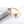 Gold ring with starfish and shell designs on a white background.