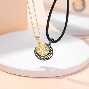 Gold and black pendant necklace on a white surface