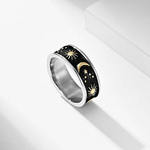 Gold celestial engraved ring with sun, moon, and stars design on a wide band