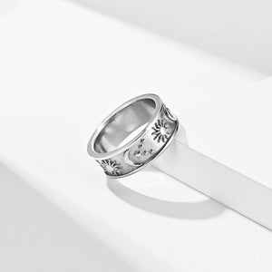 Silver celestial engraved ring with sun, moon, and stars design on a wide band