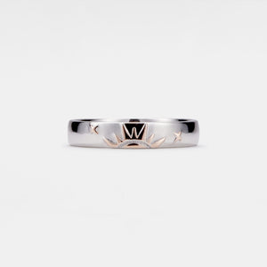Silver ring with engraved design on a white background
