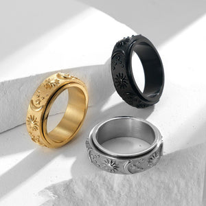 Three rings in gold, silver, and black on a dark background