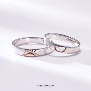 Two silver rings with rose gold accents on a white background