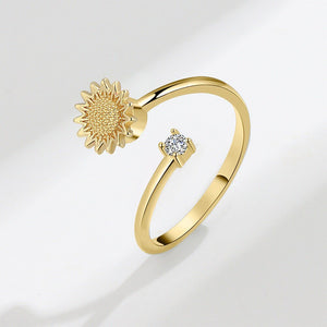 A sterling silver ring with a gold-plated sunflower design and a smaller cubic zirconia flower on top.