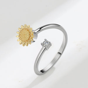A sterling silver ring with a gold-plated sunflower design and a smaller cubic zirconia flower on top.