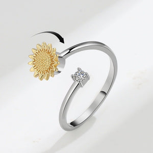Silver ring with a gold sunflower and diamond on a white background