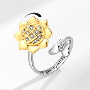 Two rings, one gold and one silver, on a light gray background.