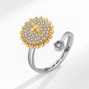 Two rings, one gold and one silver, on a white background.