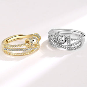 Two gold and silver rings with diamond accents on a white background