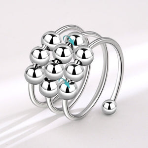 A silver-colored fidget spinner ring with multiple layered beads.