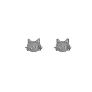 A person's hand holding a pair of silver and gold-plated opal cat stud earrings.