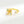 Gold ring with starfish design and gemstones on a white background