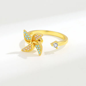 Gold ring with starfish design and gemstones on a white background