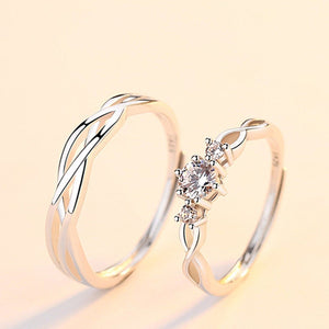 Two gold rings with diamond accents on a light beige background